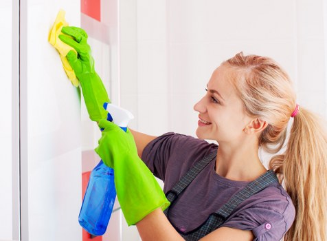 Cleaning staff following safe working practices during a commercial cleaning task